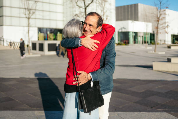 istock Elderly companions hugging warmly in sunlit outdoor setting 2198510395