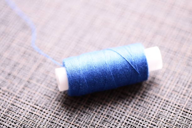 A spool of thread sits on top of a table, perfect for sewing or crafting projects.