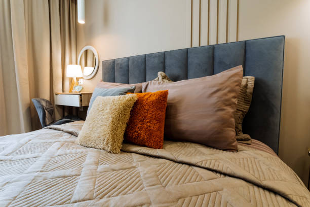 istock A wonderfully cozy bedroom, featuring a neatly made bed adorned with a soft blanket and plush pillows, creates a serene and relaxing atmosphere after a long, tiring day at work or school 2198512401