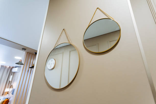 istock In a hallway, two round mirrors are beautifully hanging on the wall 2198512416