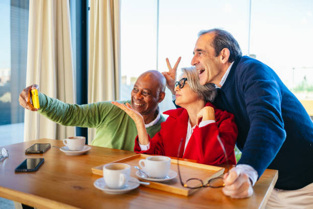 istock Group of friends taking a selfie in a cozy cafe 2198512672