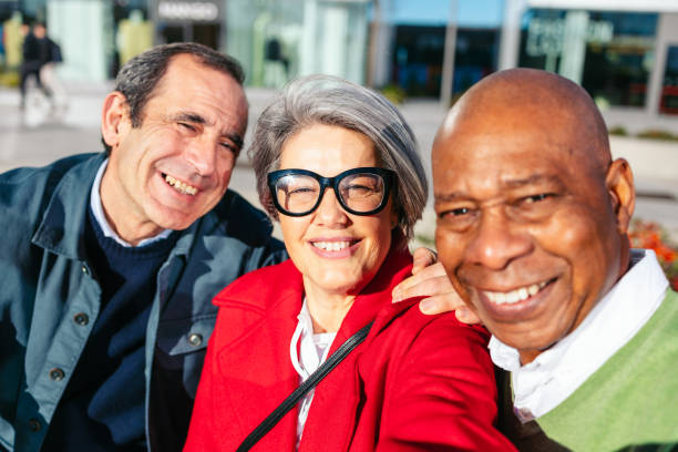 istock Three friends smiling outdoors during a shopping trip 2198512703