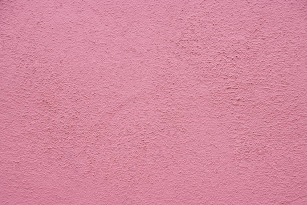 Vivid pink wall textured surface exhibiting fine details, useful as a decorative element or design background.