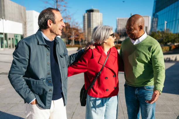 istock Three senior friends sharing a joyful moment in a city setting 2198514357