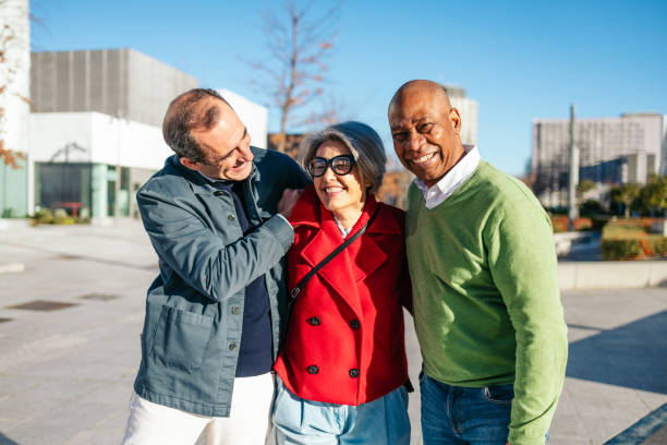 istock Three senior friends laughing together outdoors on a sunny day 2198514466