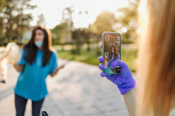 istock Volunteers with garbage bags cleaning up garbage outdoors - ecology concept. 2198514480