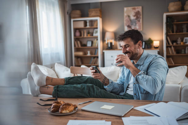 istock Man unwinding with mobile games after a busy workday 2198514952