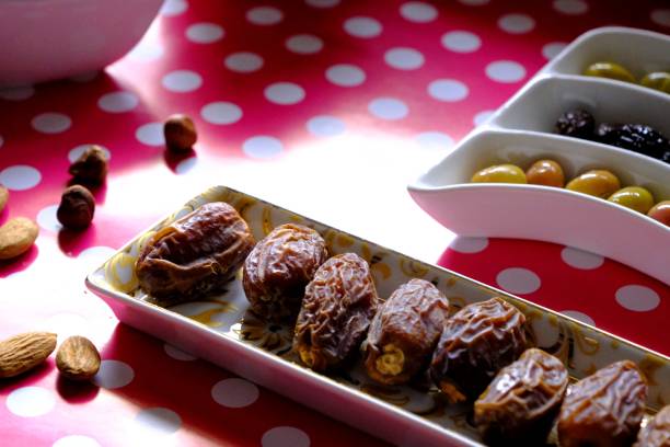 istock Ramadan iftar table, dates, olives, hazelnuts almonds, teapot and teacup. 2198515154
