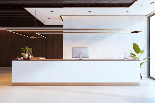 Modern reception desk with computers, stylish interior with wood paneling, stone desk, and a lamp, contemporary office environment.  3D Rendering