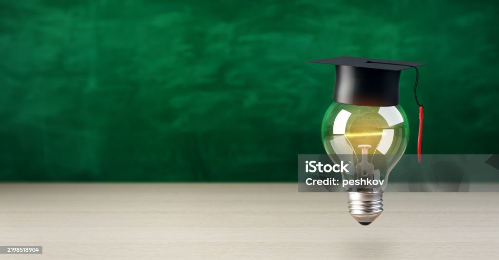 Graduation Light Graduation Cap On Glowing Light Bulb Against Green Chalkboard ...