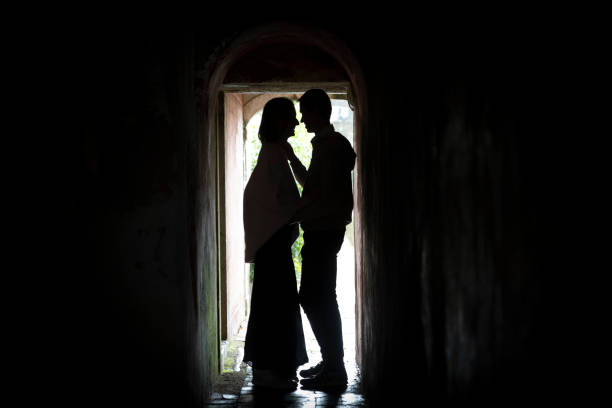 istock Romantic couple sharing intimate moment in dark archway 2198521176