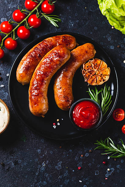 istock Fried sausages with vegetables and garlic 2198521233