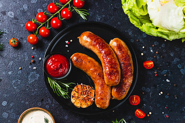 istock Fried sausages with vegetables and garlic 2198521240