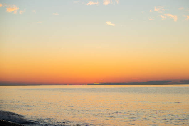 Sunset at sea, ocean backdrop and scenic waves, golden hour creates a tropical scene.