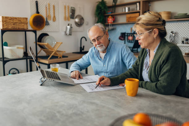 istock A senior couple wears eyeglasses for better concentration while managing a pension at home 2198523016