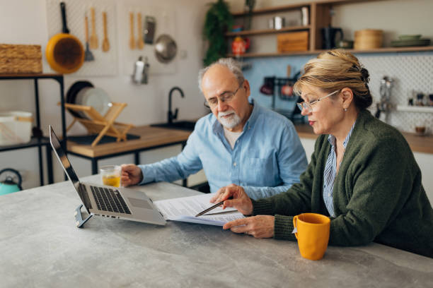 istock A senior married couple wears eyeglasses for better concentration while managing a pension at home 2198523025