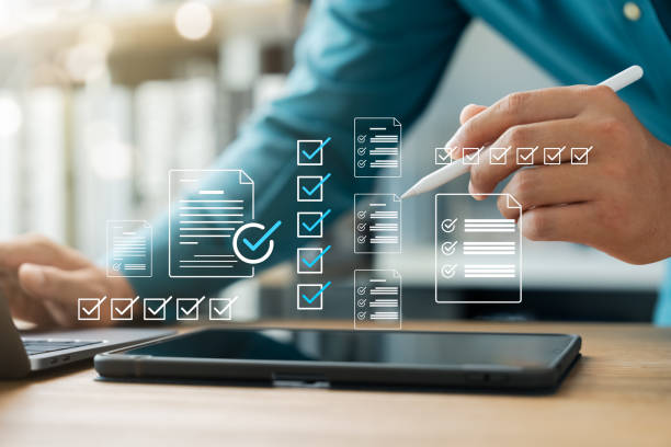 istock Business performance monitoring, businessman using laptop and tablet making correct mark. 2198523855