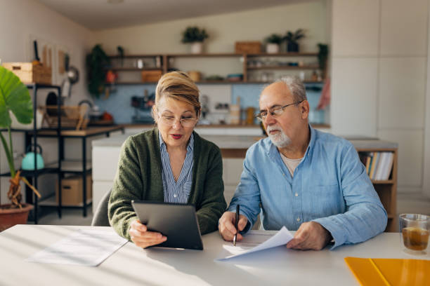 istock Senior couple thinking, discussing, making decisions and evaluating options in organizing pension while looking at a digital tablet screen 2198523909