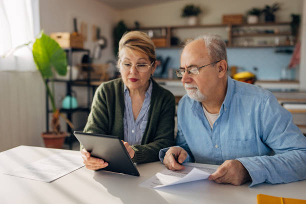 istock Senior married couple thinking, discussing, making decisions and evaluating options in organizing pension while looking at a digital tablet screen 2198523934