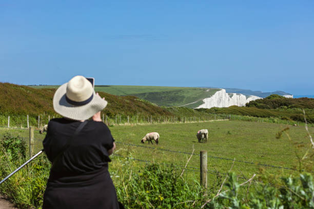 Senior woman on the path towards famous Seven Sisters chalk cliffs