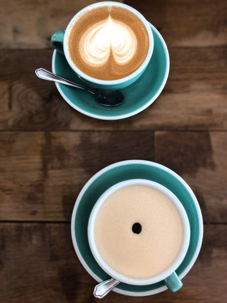 istock two coffees on a wooden table in teal cups 2198525034