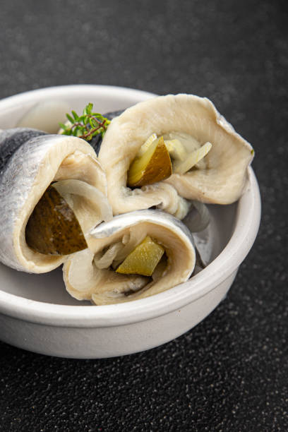 istock Rollmops herring roll with onion and pickles appetizer fresh tasty food dish delicious gourmet food background on the table rustic food top view copy space vegetarian food pescetarian diet 2198533510