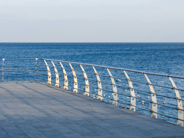 istock Plank ledge with handrails by the sea 2198534761