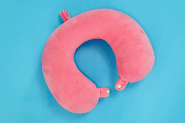 istock A pink travel pillow or neck pillow on a blue background 2198535783