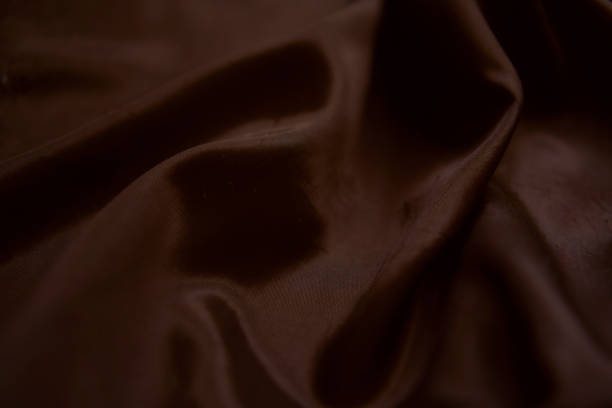 istock abstract background,  a wallpaper, fabric waves, color gradient, silk, satin Mocha Mousse color 2198539312