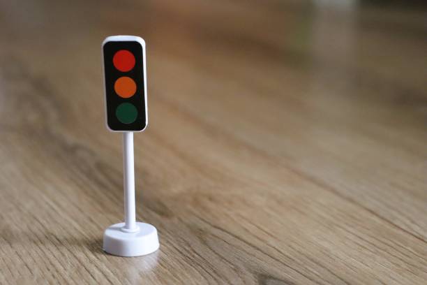 istock A Miniature Traffic Light Model on a Wood Floor, creating a vibrant and engaging atmosphere 2198540152