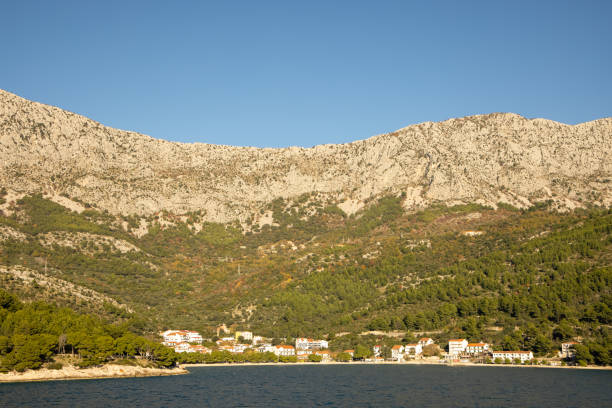 istock Serene Coastal Town Nestled Against Mountain Range 2198542721