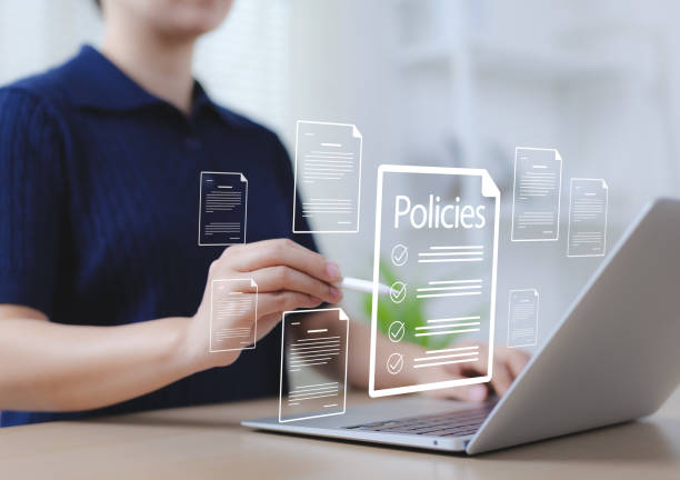 istock Online policy document management concept. A person interacting with digital policies documents on a laptop, symbolizing online documentation, governance, compliance, digital information management, 2198542800