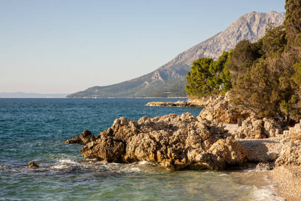 istock Serene Coastal View with Majestic Mountain Backdrop 2198542894