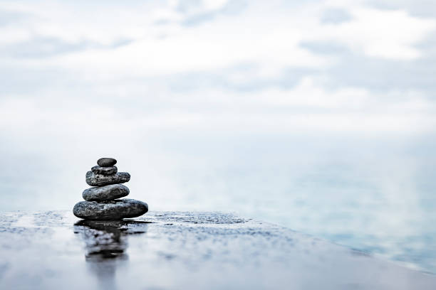 Zen stones by the sea with blurred horizon