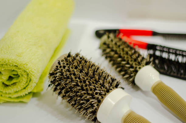 round brushes, combs, and a soft towel for professional hair styling. Perfect for salons, barbers, and personal grooming.