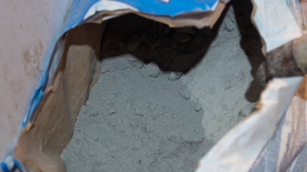 istock Dry cement in a paper bag with a trowel close-up 2198548135