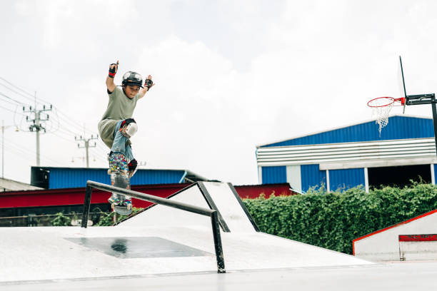 A fearless kid performs an intense skateboarding trick on a ramp, balancing with precision. The urban skatepark setting highlights the thrill of extreme sports and youth talent.