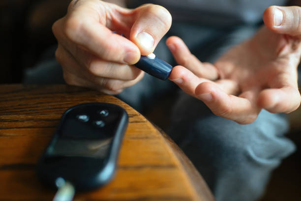 istock Senior man with blood sugar test at home 2198550122