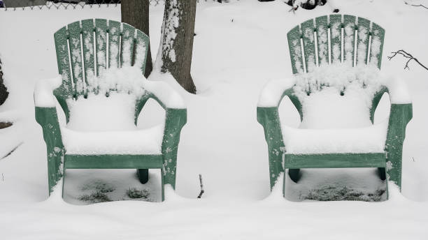 istock Two empty chairs covered in snow during winter in a quiet yard 2198550417