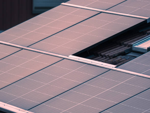 istock Photovoltaic modules on old roof at sunset 2198550574