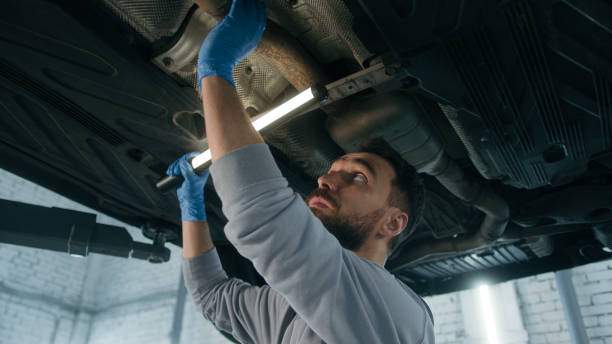 istock Caucasian guy mechanical serviceman working underneath car in garage checking automobile maintenance mechanic man in auto repair service shop vehicle diagnostics survey truck using flashlight light 2198550691