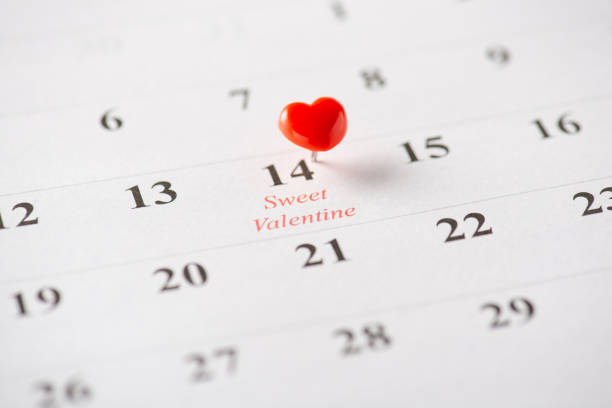 istock A small red heart-shaped pin marking Valentine's Day on a calendar page, symbolizing love 2198550744