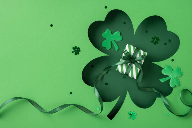 istock Festive setup featuring a green St. Patrick's themed gift box surrounded by clovers and decorations 2198550746