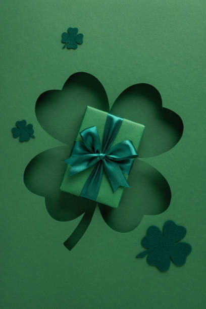 istock Green vertical wrapped gift box with clover cutouts, symbolizing St. Patrick's Day themes and designs 2198550753