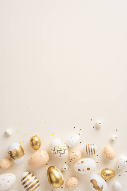 istock Golden and white vertical Easter eggs with intricate designs scattered on a beige background, ideal for seasonal celebrations. 2198550814