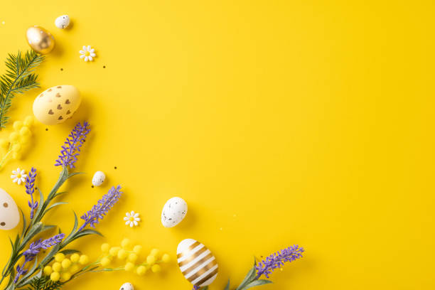 istock Bright Easter-themed setting with decorative eggs, yellow and purple flowers, and yellow background 2198550816