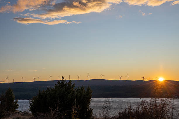 istock Wind Turbines Against a Glowing Sunset 2198550878
