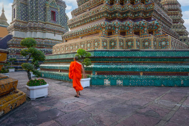 istock Buddhist monk walking in wat pho temple, bangkok, thailand 2198553484