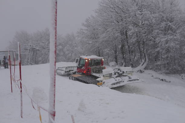 istock A snow groomer works on a ski slope. Heavy snowfall. 2198555499