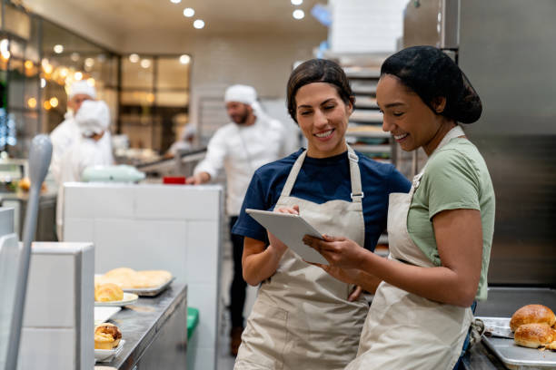 istock Women working at the bakery and looking at a recipe on a tablet 2198556095
